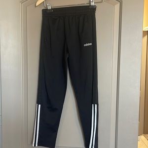 Adidas black pants with three stripes and zipper at ankle size Medium